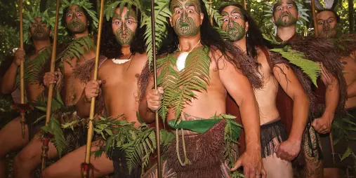 Group of Māori warriors performing the haka at Mitai Māori Village in Rotorua.
