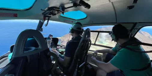 Passengers inside a helicopter flying toward White Island, Bay of Plenty