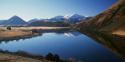 Scenic view of Lake Pearson with mountain reflections near Arthur’s Pass, Canterbury