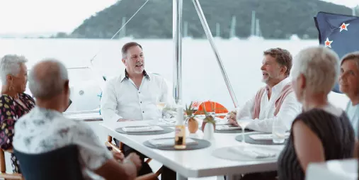 Group enjoying a lively conversation in the cockpit of a catamaran