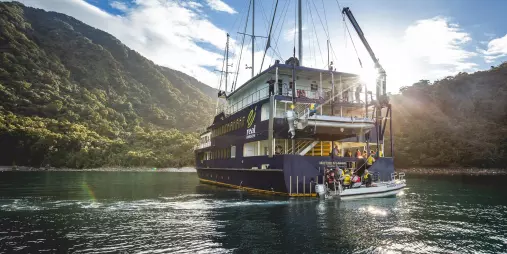 Milford Mariner launching a tender boat during an overnight cruise in Milford Sound