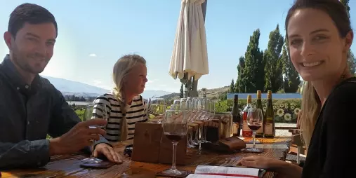 Visitors enjoying wine tasting at Bannock Brae Vineyard with views over Central Otago.