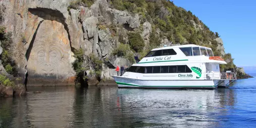 Chris Jolly Outdoors' Cruise Cat viewing the Māori Rock Carvings on Lake Taupō