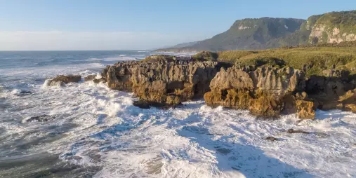 Aerial view of Punakaiki Pancake Rocks and crashing waves on the West Coast of New Zealand